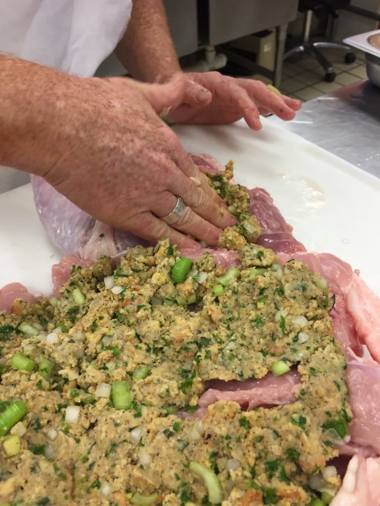 layering stuffing into the turducken