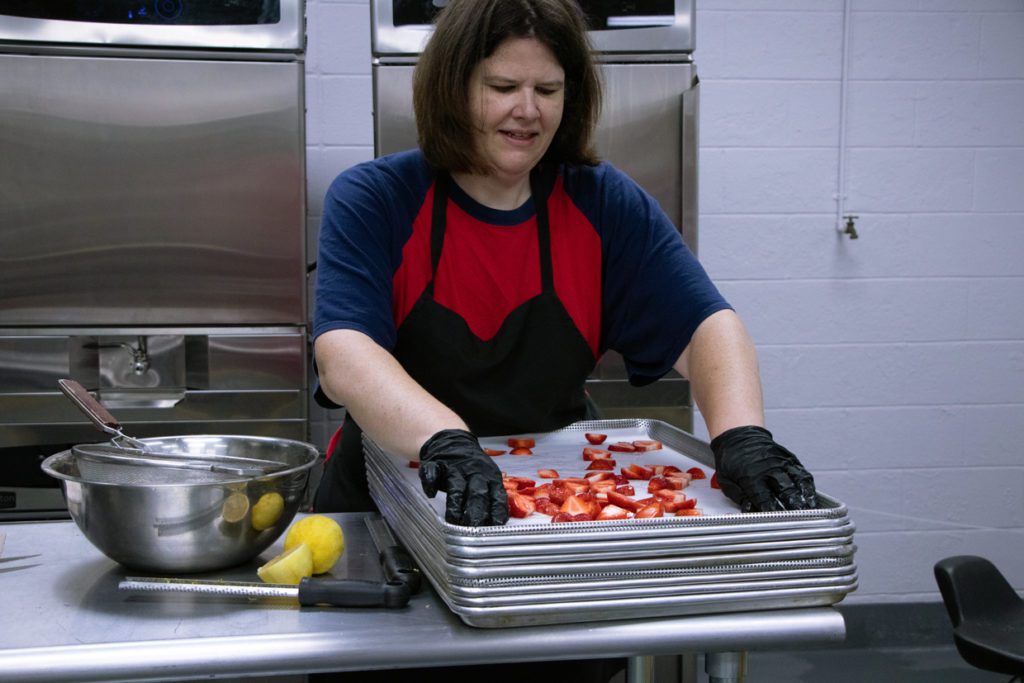 Sam slicing strawberries