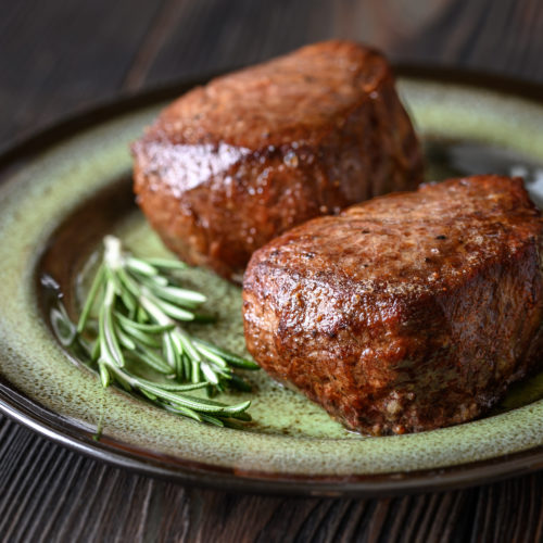 Filet mignon with fresh rosemary on the plate